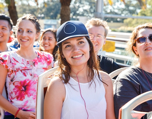 Girl using audio guide on Sydney Blue Mountain tour bus.