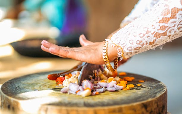 Chopping vegetables at Paon Bali Cooking Class in Ubud.