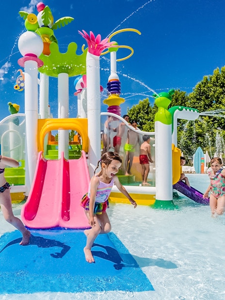 Children playing at water playground in Parque Warner Beach, Madrid.