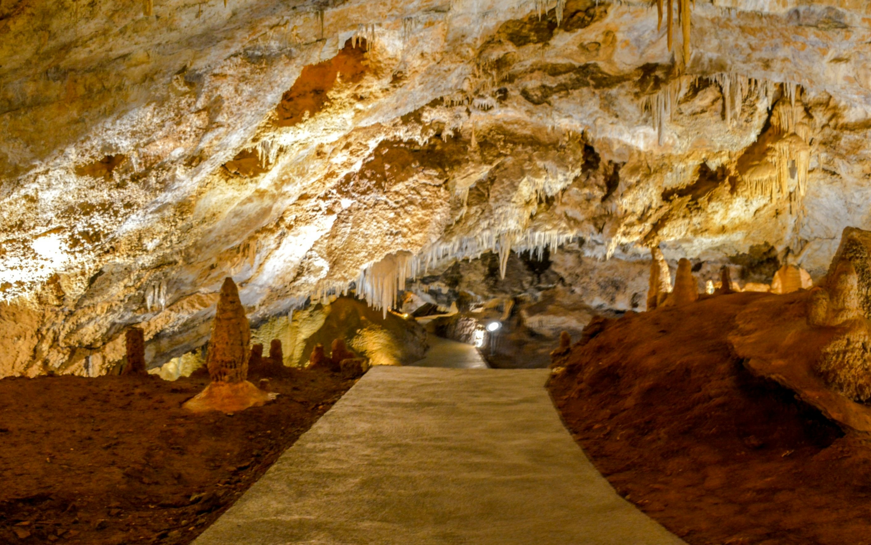 Pathway through stalactites and stalagmites inside Lipa Cave, Montenegro.