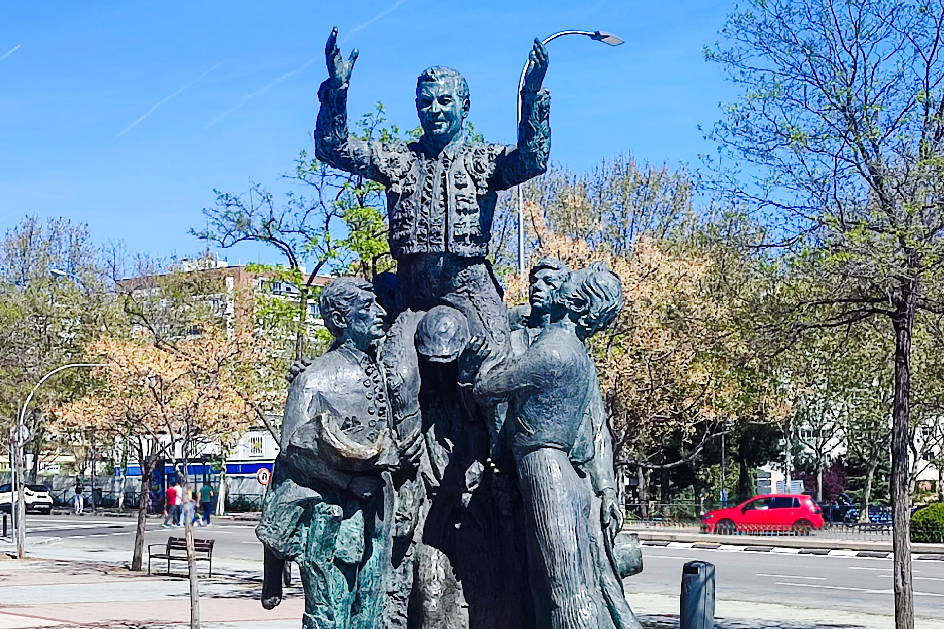 Statue of bullfighter being lifted by supporters in Madrid, seen on a private 2-hour tour.