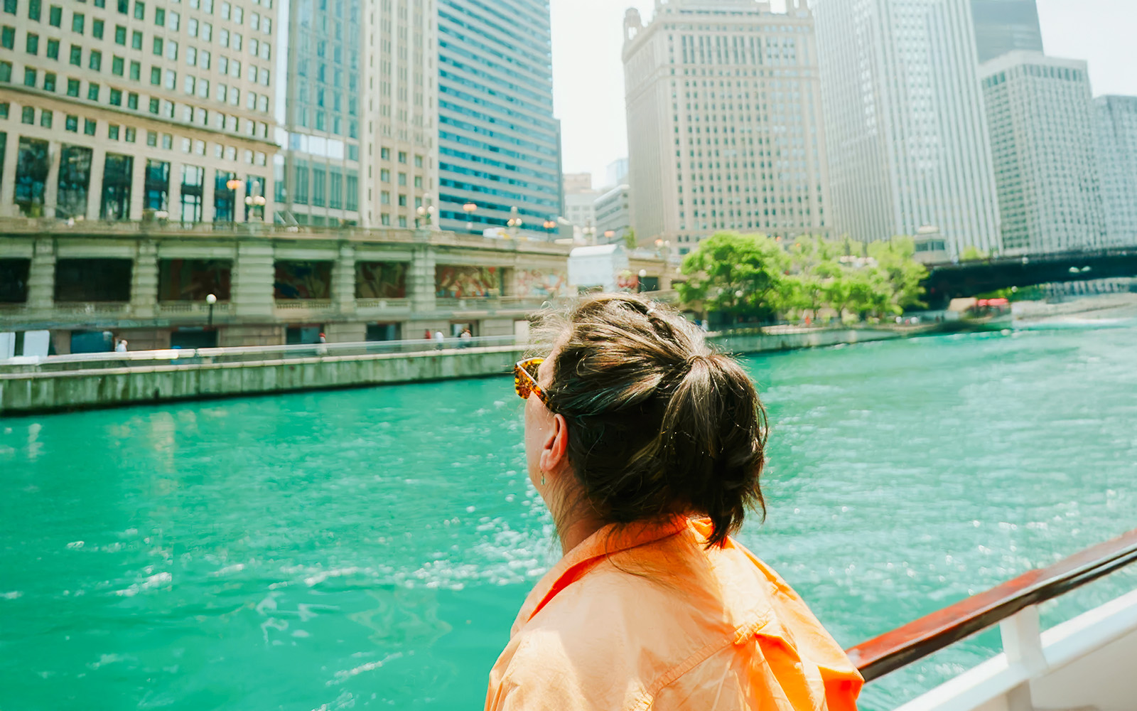Person on a boat enjoying the Chicago River Architecture Tour with city skyline views.