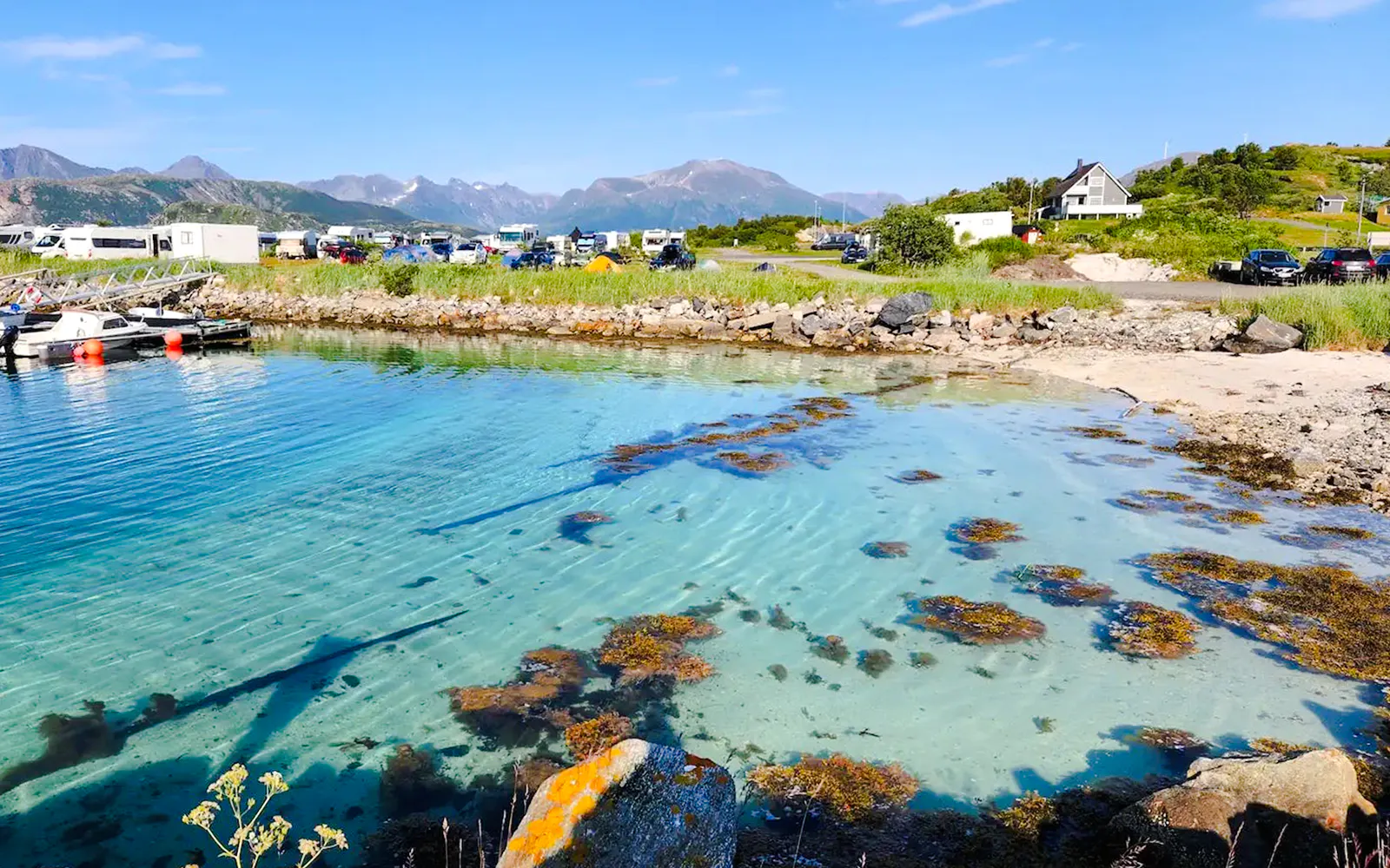 Clear waters of Sommarøy Fjord with distant mountains, Tromsø.