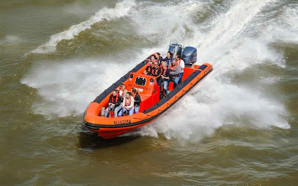 RIB speedboat with passengers touring Rotterdam Harbour.