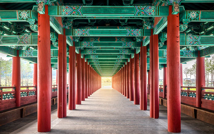Traditional Korean architecture with red columns and ornate ceiling in Gyeongju, South Korea.