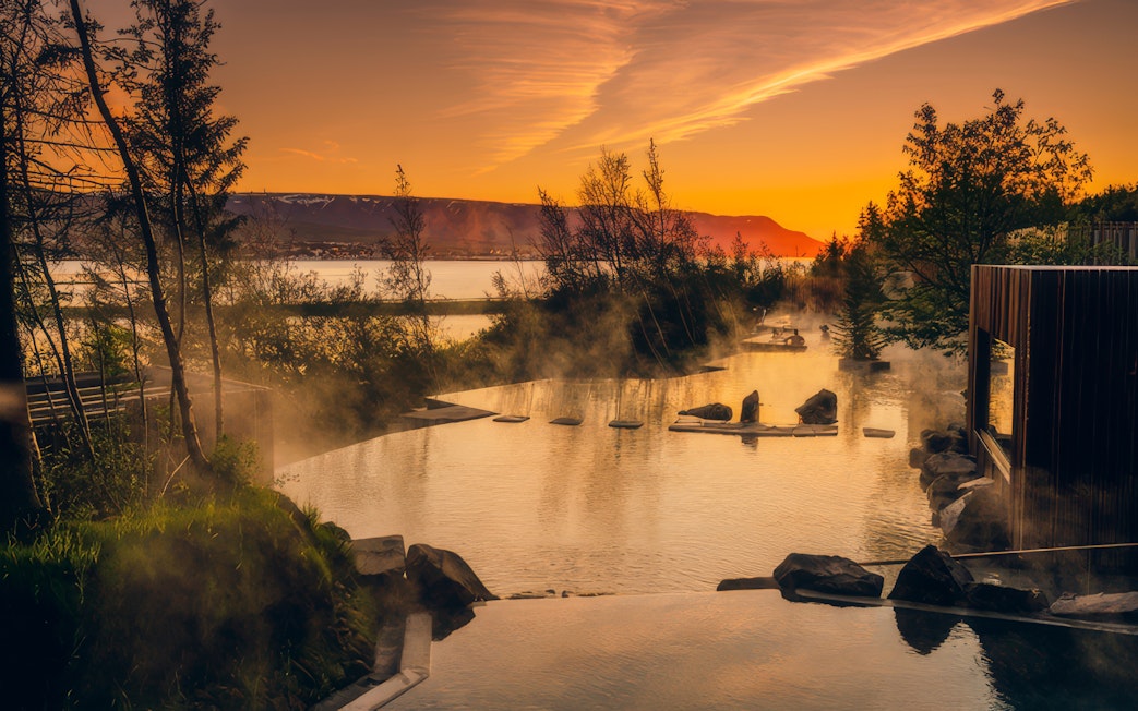 Geothermal spa at sunset in Vaðlaskógur forest near Akureyri, North Iceland.