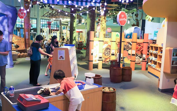 Children exploring interactive exhibits at Science Centre's KidsStop.