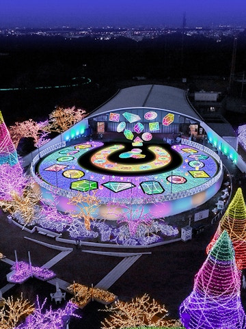 Yomiuriland illuminated night display with colorful lights and geometric patterns.