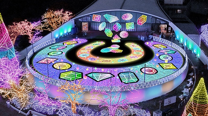 Yomiuriland illuminated night display with colorful lights and geometric patterns.