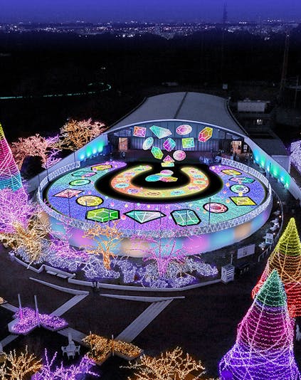 Yomiuriland illuminated night display with colorful lights and geometric patterns.