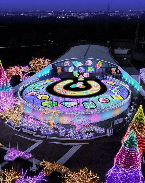 Yomiuriland illuminated night display with colorful lights and geometric patterns.