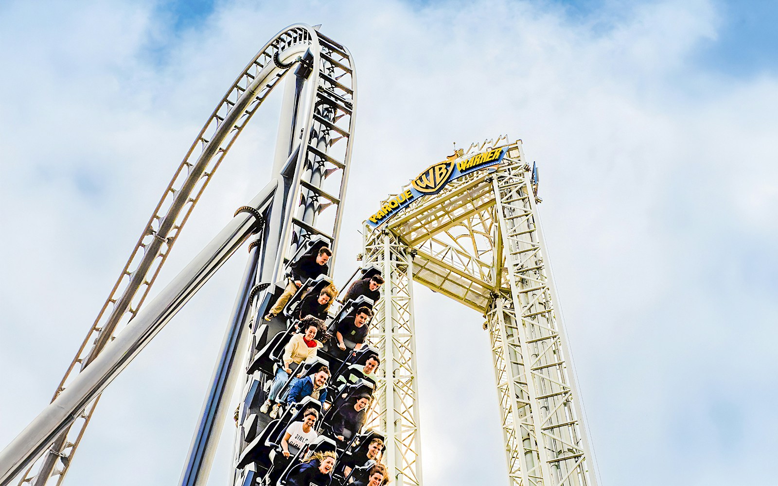 Parque Warner roller coaster with vibrant loops and twists in Madrid, Spain.