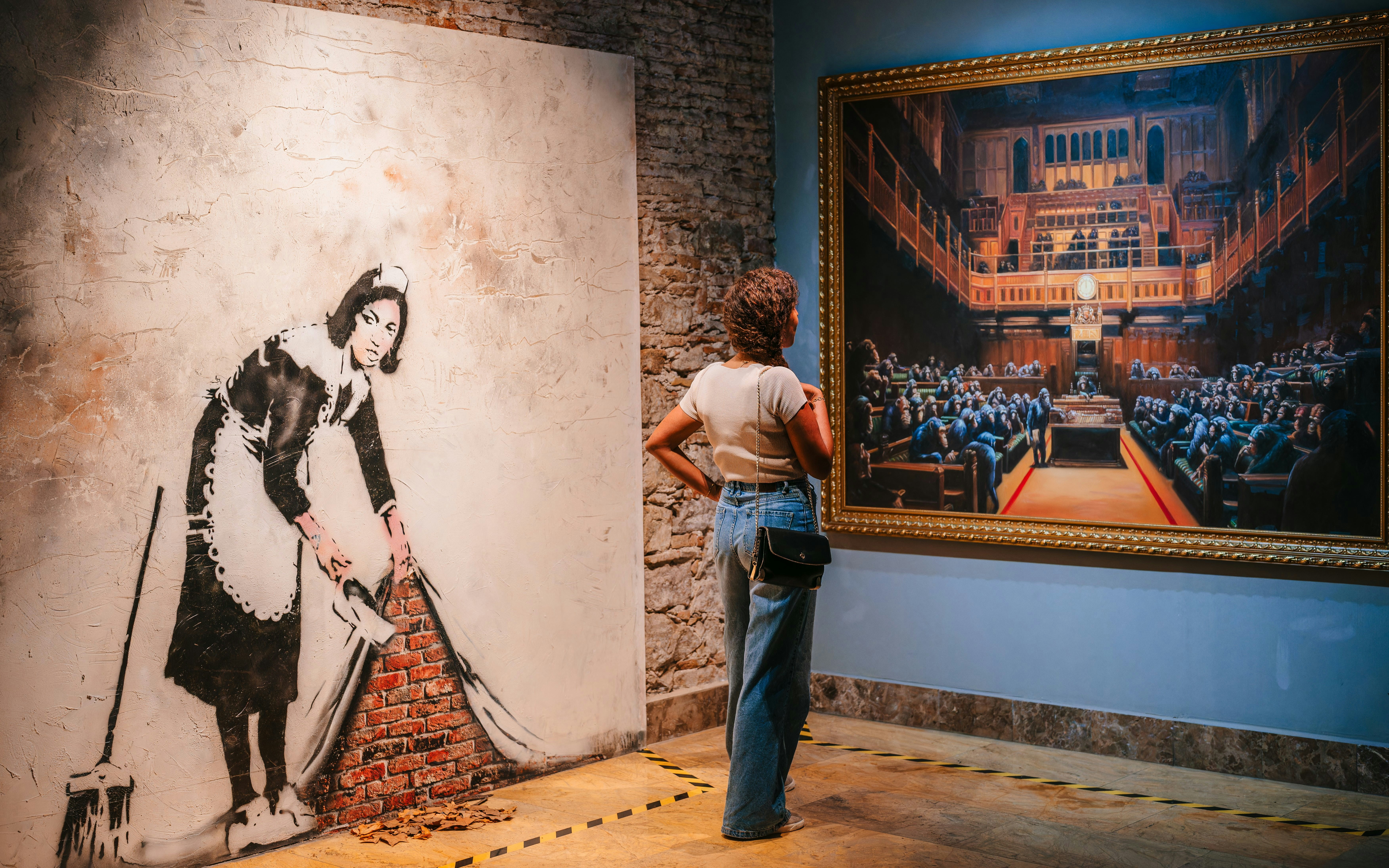 Tourist viewing Banksy artwork at Banksy Museum in Barcelona.