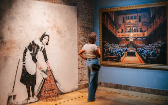 Tourist viewing Banksy artwork at Banksy Museum in Barcelona.