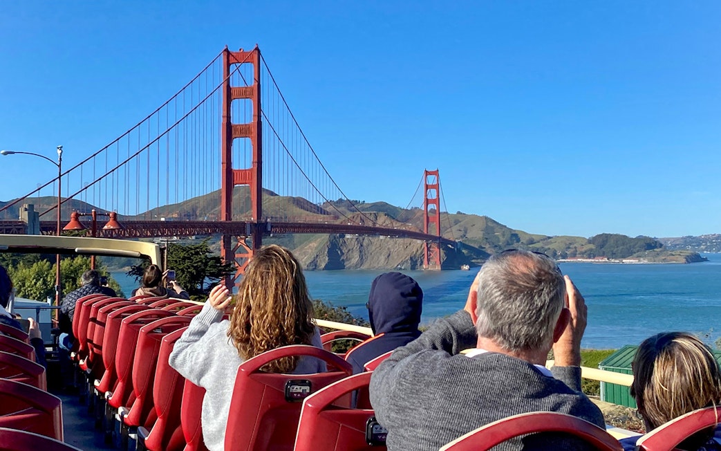 Open-top bus tour with view of Golden Gate Bridge, San Francisco.