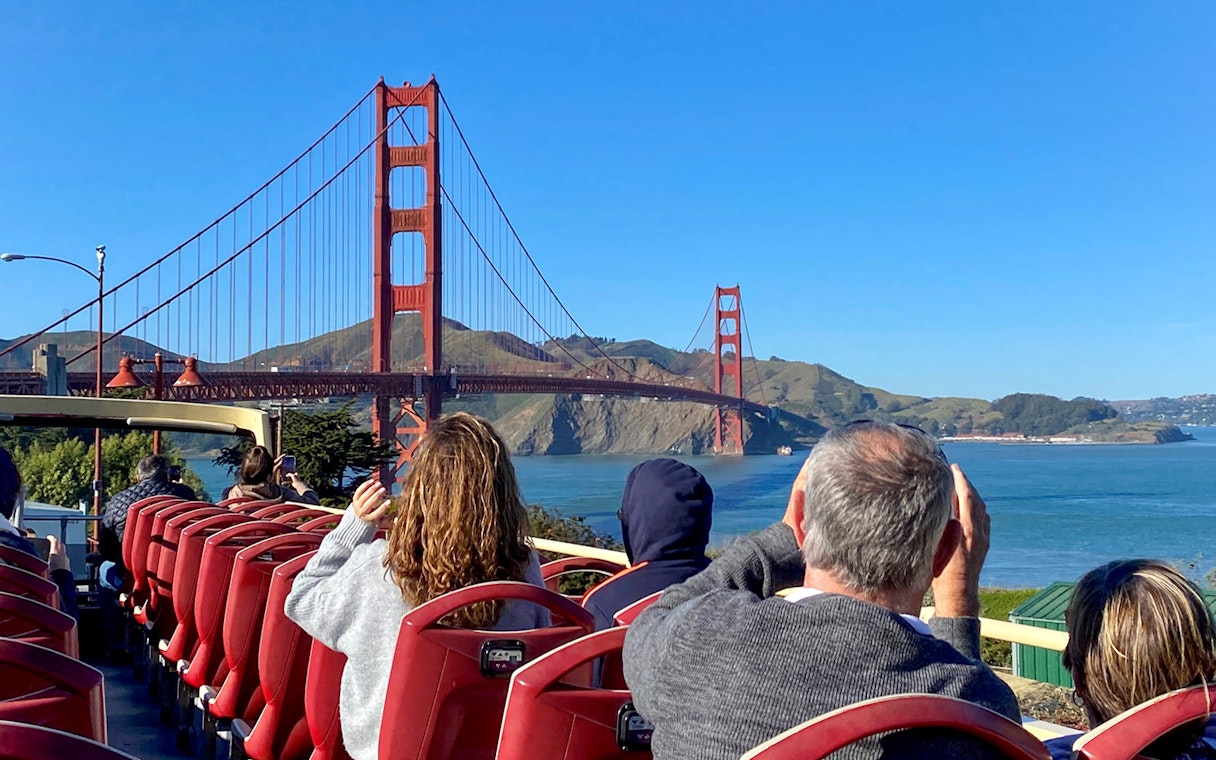 Open-top bus tour with view of Golden Gate Bridge, San Francisco.