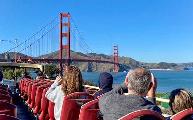 Open-top bus tour with view of Golden Gate Bridge, San Francisco.