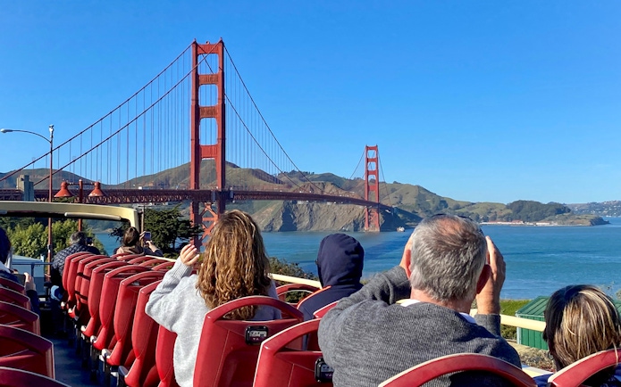 Open-top bus tour with view of Golden Gate Bridge, San Francisco.