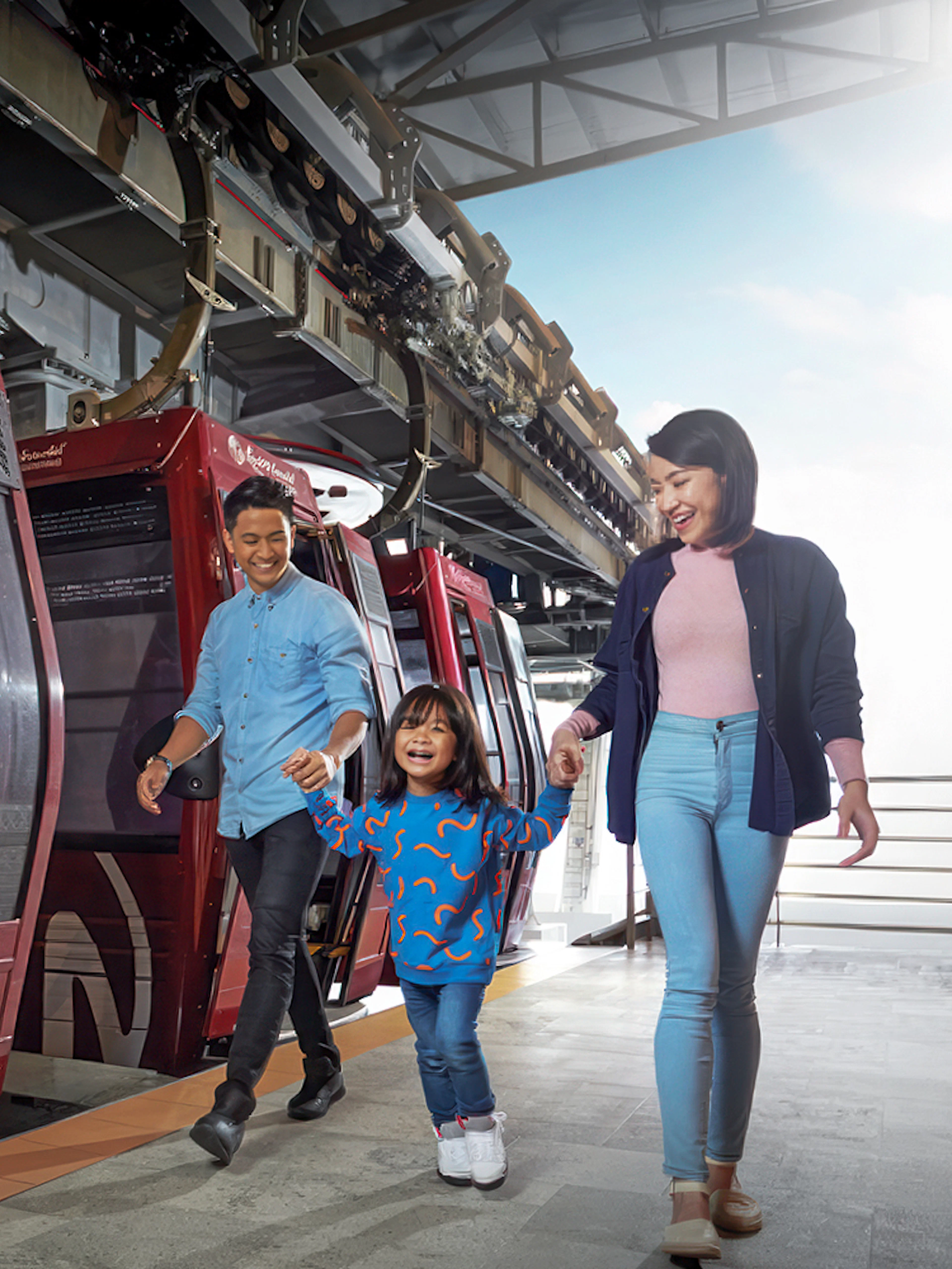 Family boarding cable car at Genting Awana SkyWay, Malaysia.