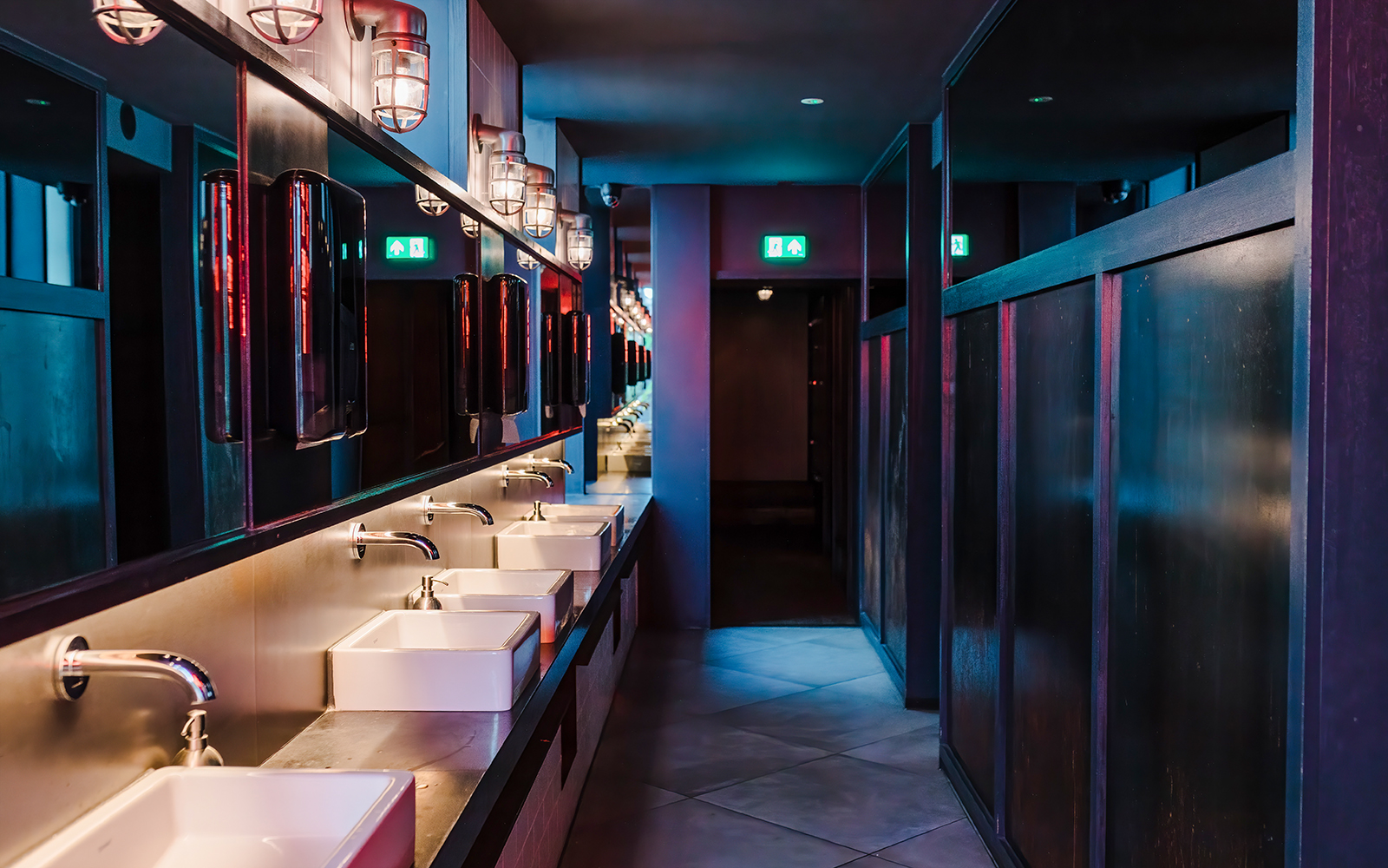 Interior of modern night club restroom in dark colors
