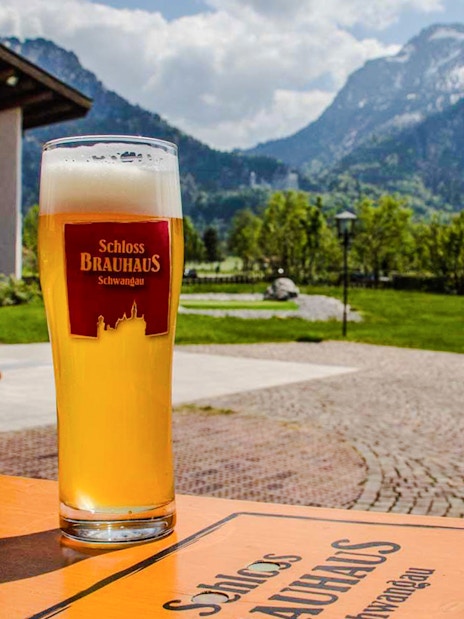 Bavarian beer at Schloss Brauhaus Schwangau with mountain view near Neuschwanstein Castle.