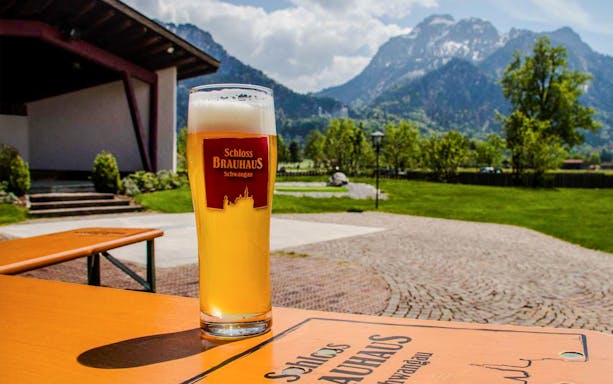 Bavarian beer at Schloss Brauhaus Schwangau with mountain view near Neuschwanstein Castle.
