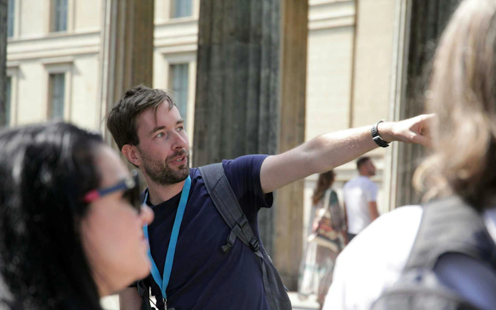 Guide explaining history during Berlin World War II and Third Reich walking tour.