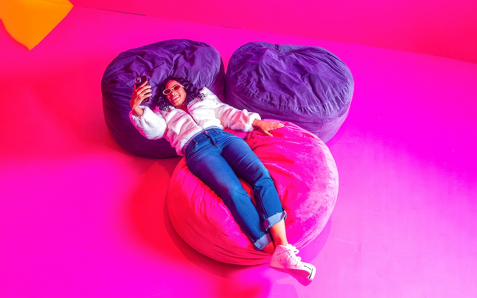 Guest relaxing on colorful bean bags at Dopamine Land.