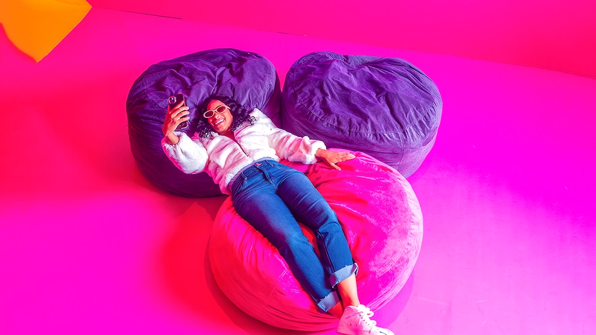 Guest relaxing on colorful bean bags at Dopamine Land.