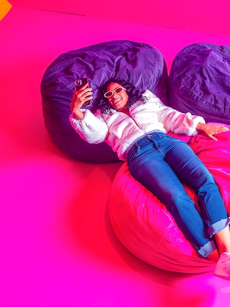 Guest relaxing on colorful bean bags at Dopamine Land.
