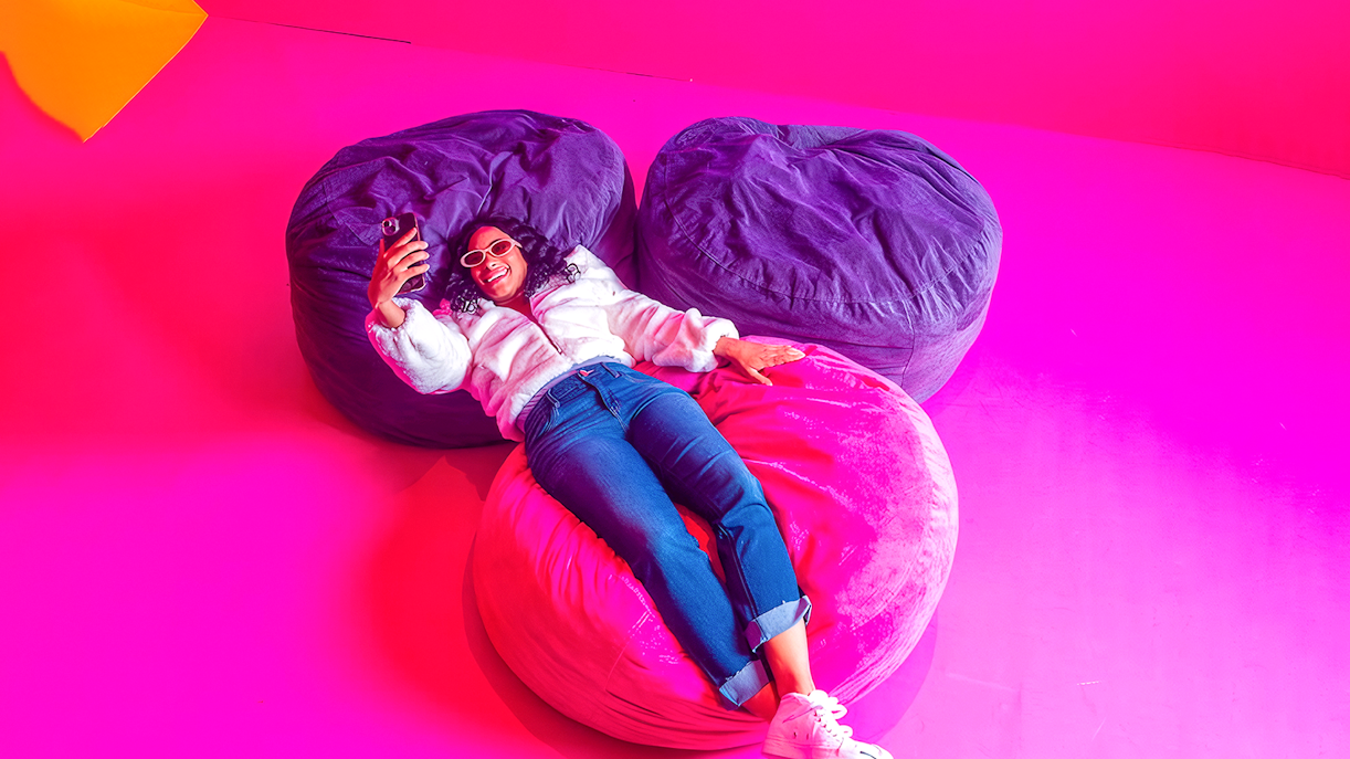 Guest relaxing on colorful bean bags at Dopamine Land.