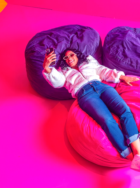 Guest relaxing on colorful bean bags at Dopamine Land.