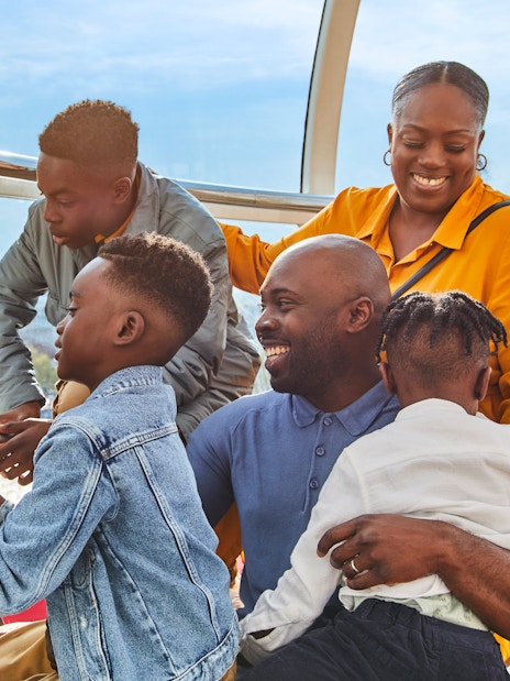 Family enjoying view of Big Ben from London Eye capsule.