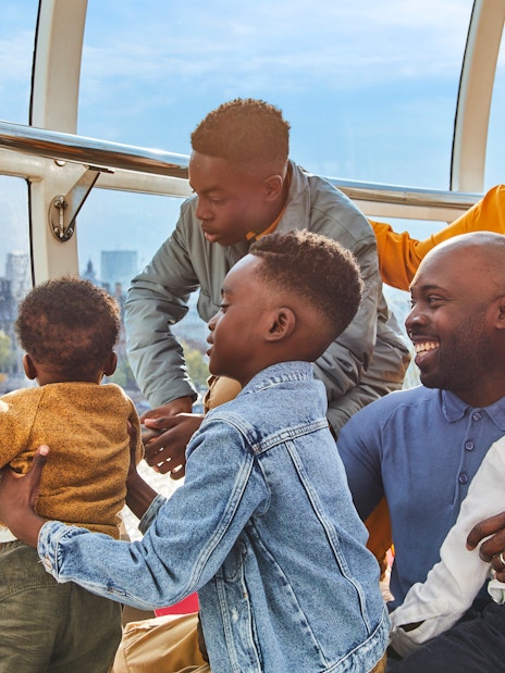 Family enjoying view of Big Ben from London Eye capsule.