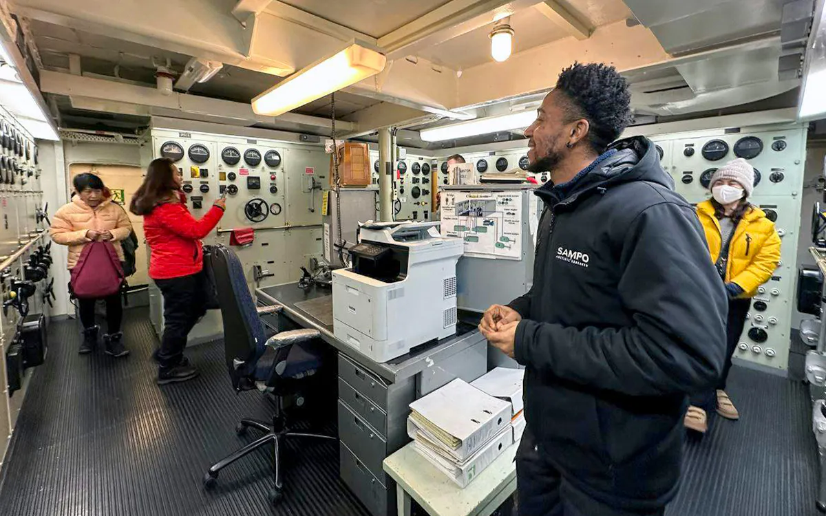 Tourists exploring the control room of Icebreaker Sampo during a morning cruise.