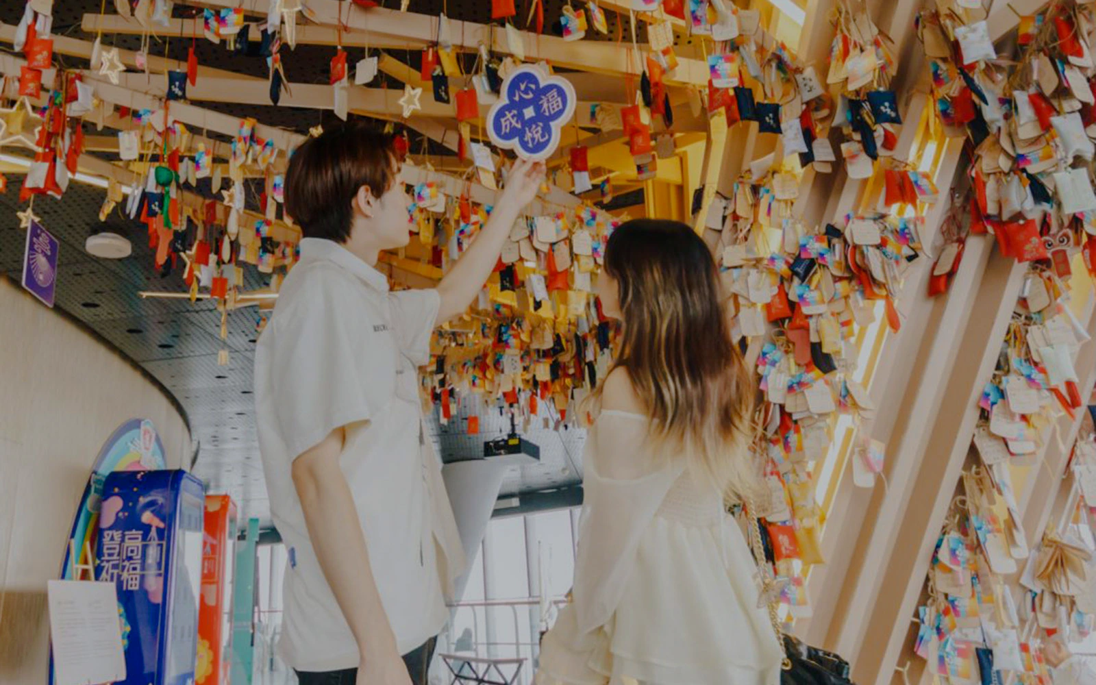 Visitors viewing colorful hanging wishes inside Shanghai Tower.