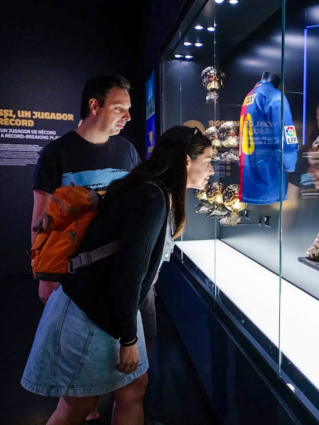 Visitors viewing Messi memorabilia at Spotify Camp Nou Barça Museum.