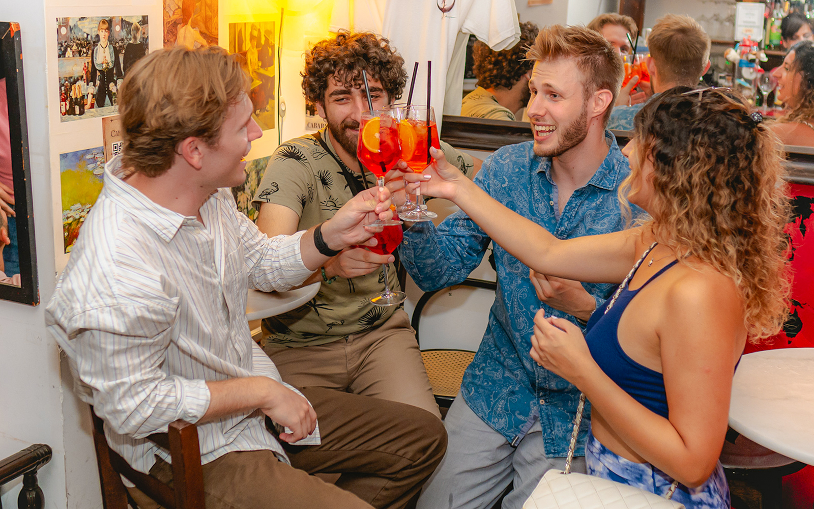 Group of friends enjoying drinks at a lively bar in Rome.