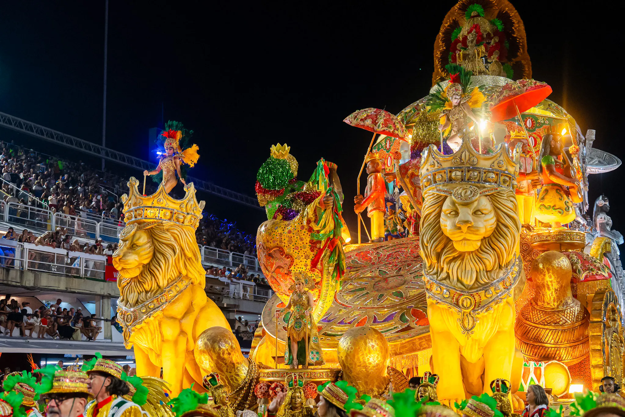 Sambadrome float with dancers and lion sculptures at Rio Carnival 2027 parade, Rio de Janeiro.
