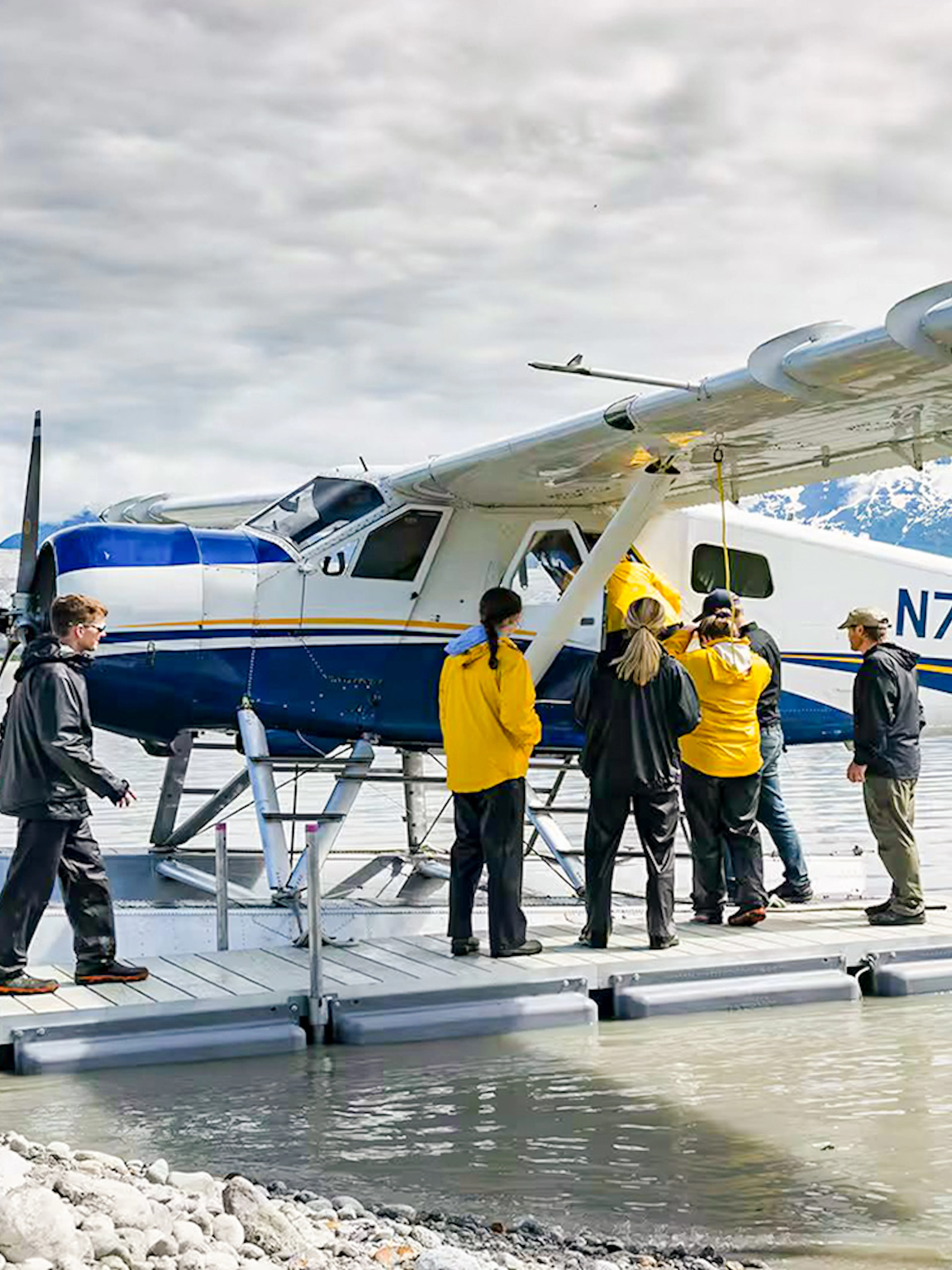 Seaplane on lake with people boarding, glacier and mountains in background, Norris Adventure tour.