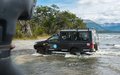 4x4 vehicle driving through water on Off-Road tour of Lakes Escondido and Fagnano.