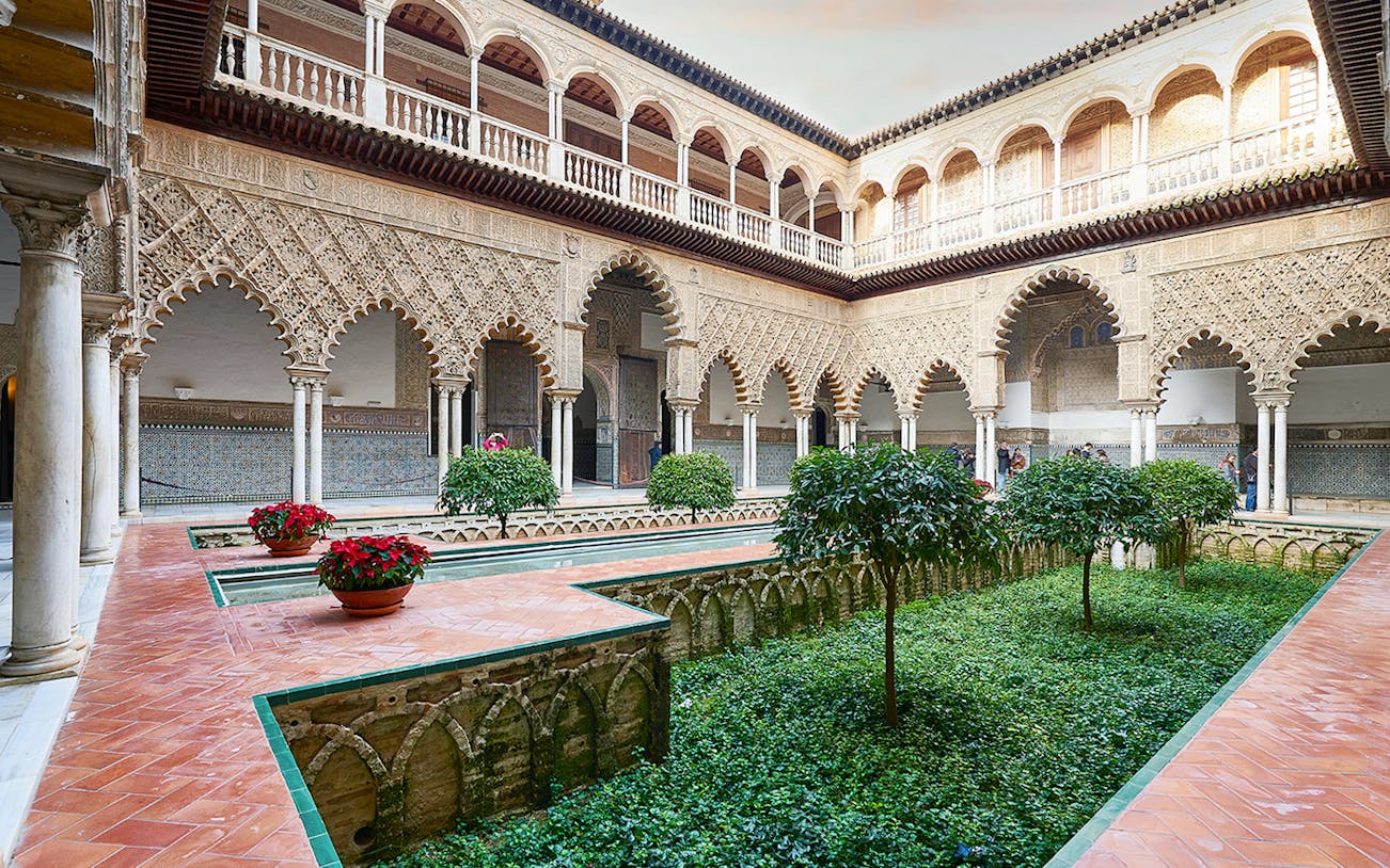Patio de las Muñecas courtyard with intricate arches, Royal Alcazar of Seville.