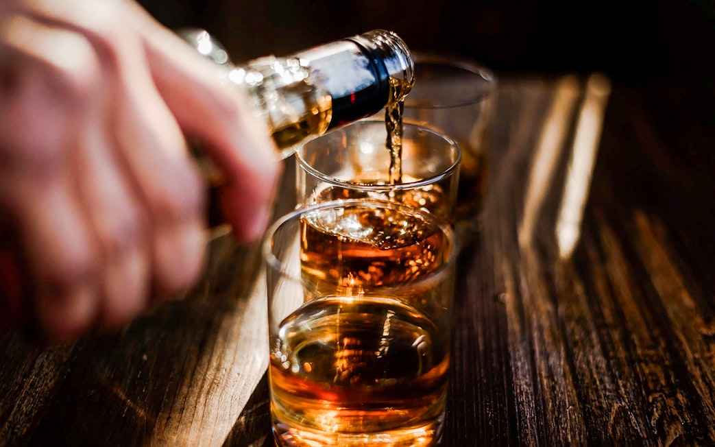 Whiskey being poured into glasses at the Irish Whiskey Museum tour.