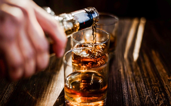 Whiskey being poured into glasses at the Irish Whiskey Museum tour.