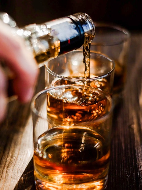 Whiskey being poured into glasses at the Irish Whiskey Museum tour.