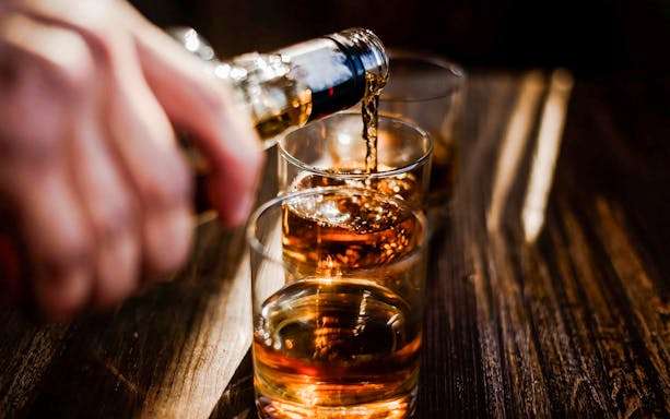 Whiskey being poured into glasses at the Irish Whiskey Museum tour.