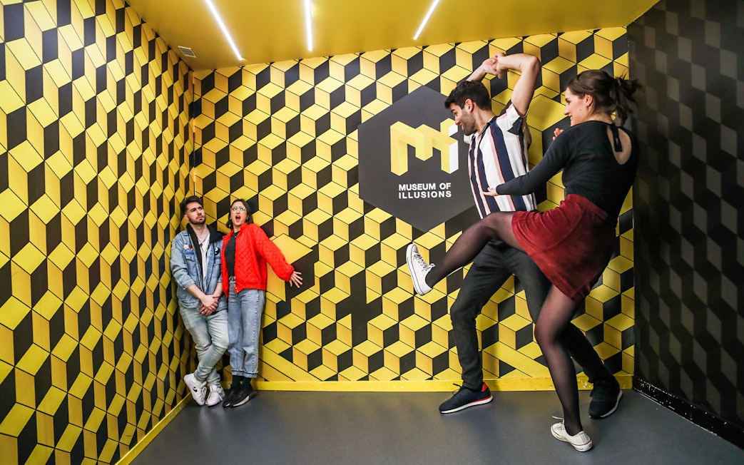 Visitors interacting with optical illusions at the Museum of Illusions.