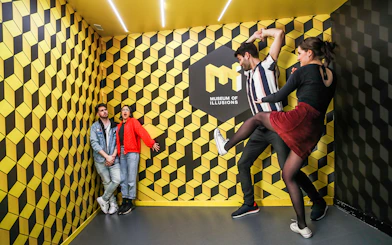 Visitors interacting with optical illusions at the Museum of Illusions.