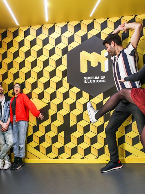 Visitors interacting with optical illusions at the Museum of Illusions.