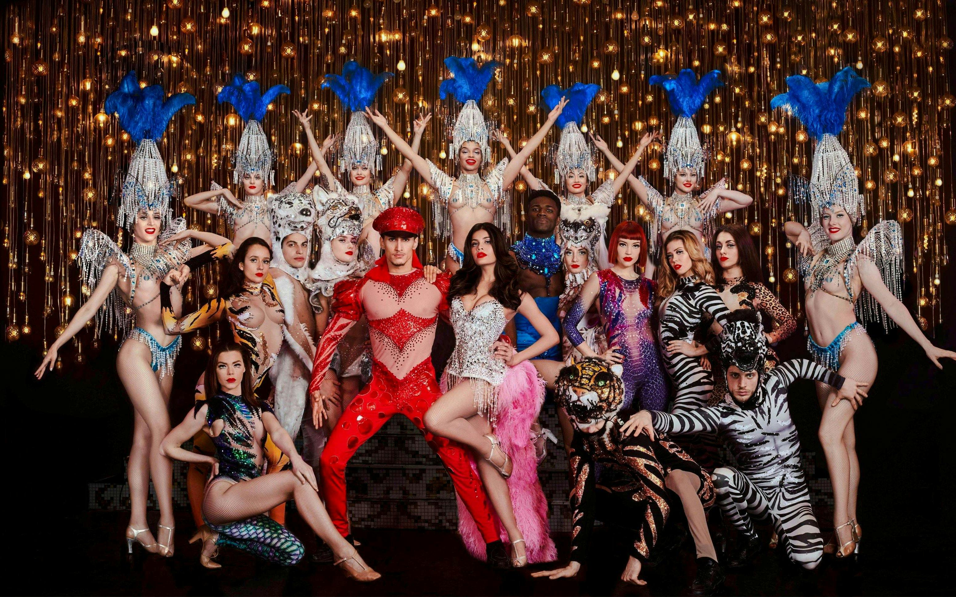 Performers in elaborate costumes on stage during Paris Bastille Day Dinner Cruise.